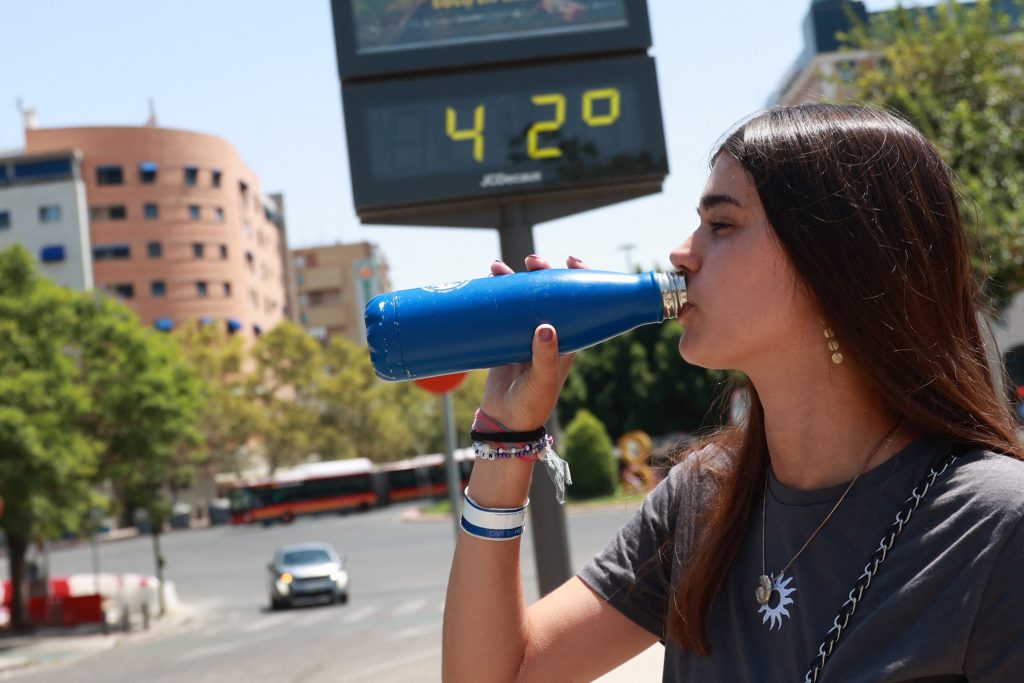 A young woman drinks water to withstand the high temperatures. On August 10, 2024, in Seville (Andalusia, Spain). A fourth heat wave is affecting the whole country from Friday until Sunday, with temperatures above 40ºC. Photo by Rocío Ruz / Europa Press