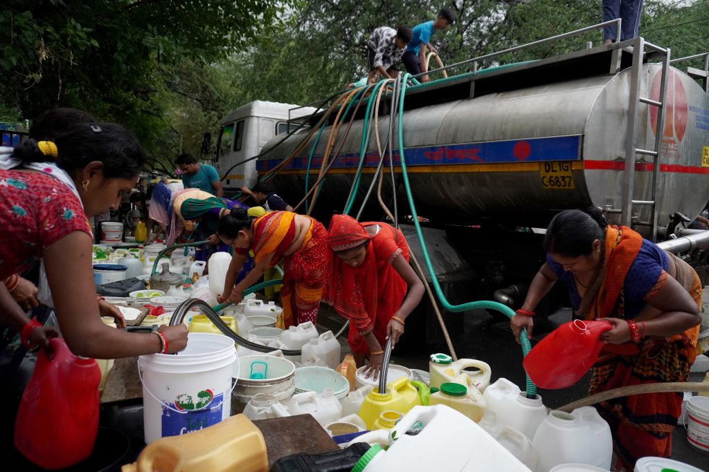 Residents fill their plastic containers with drinking water from a municipal tanker, on a hot summer day in New Delhi, India. health-based heatwave categorizing and naming