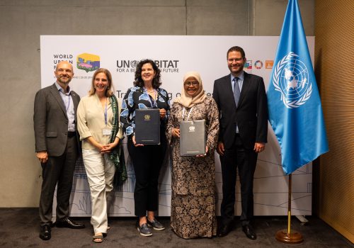 Image of Arsht-Rock team and UN-HABITAT team holding signed MOUs at the World Urban Forum in Katowice, Poland. Global chief heat officer announcement.