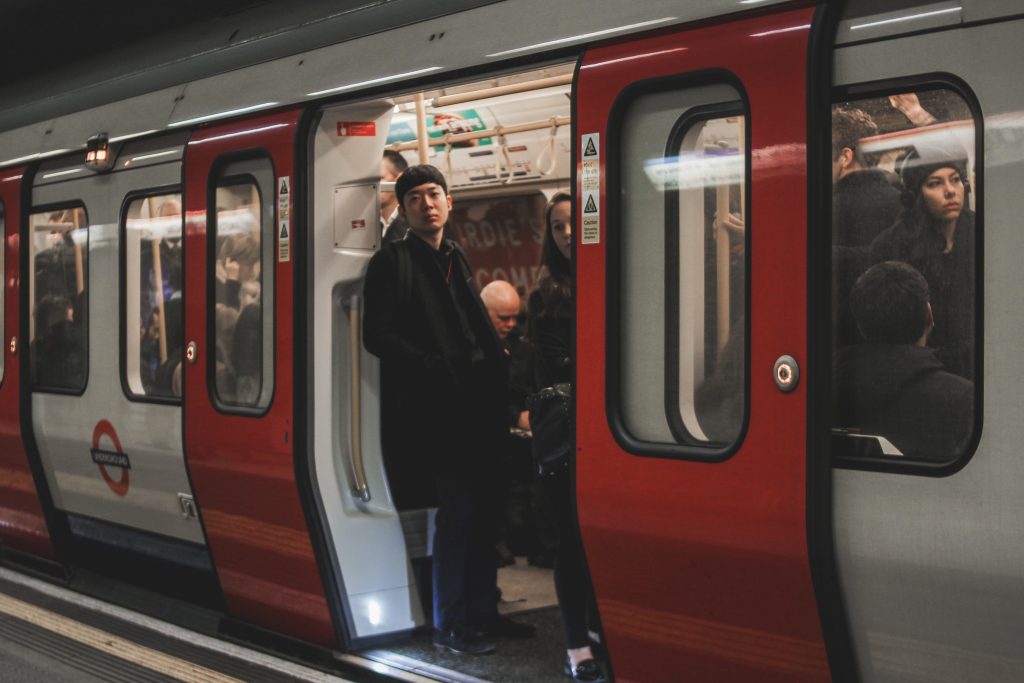 Image of man looking out of open subway doors. Subways and metros can heat up quickly, making it harder for people to commute and impacting economies.