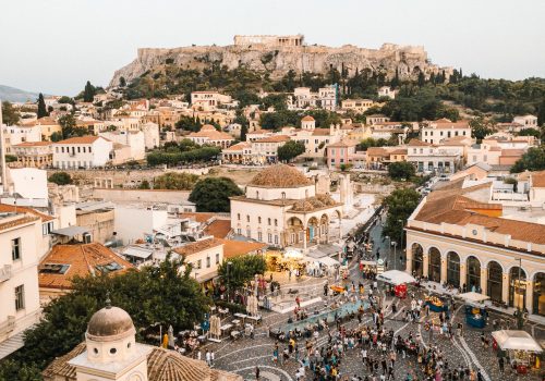 Monastiraki square in Athens, Greece. Shot from a rooftop bar on the other side of the street. An incredible view of the Acropolis and surrounding city. Photo by Andrea Leopardi on Unsplash.