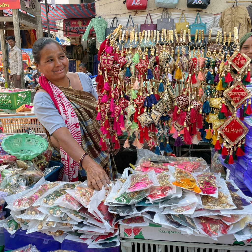 Image of woman selling items in an open air market.