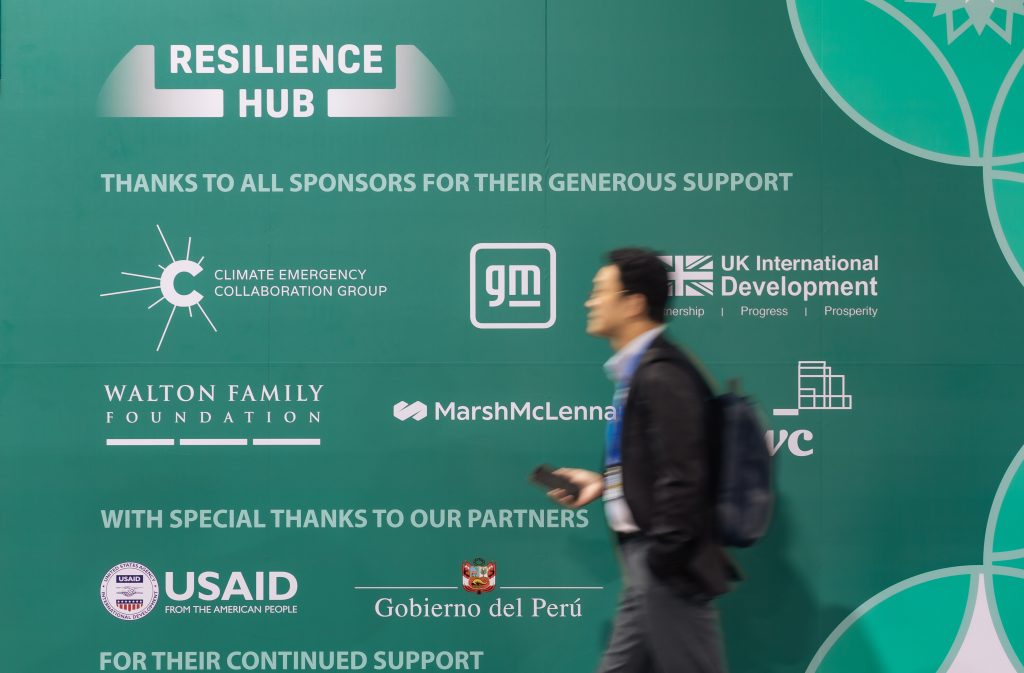 Man walking in front of exterior wall of the COP Resilience Hub.