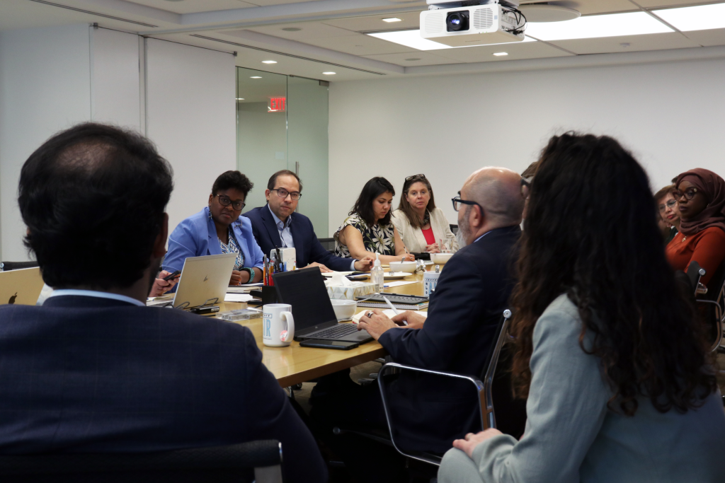 Image of FINI co-chairs Yamide Dagnet and Jorge Gastelumendi sitting at table with other participants.